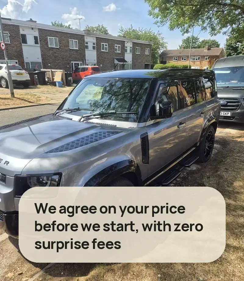 We agree on your price before we start, with zero surprise fees - silver Land Rover Defender 110 detailed at the kerb with the VPA van behind