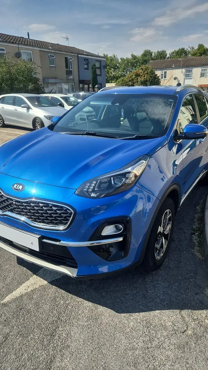 Blue Kia Sportage with a clean bonnet and bright wheels